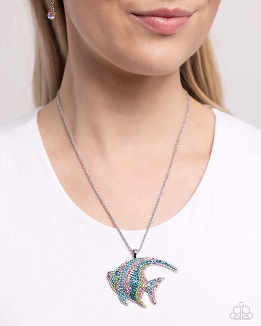 Woman wearing Tropical Talent Multi Paparazzi Oceanic Necklace with silver angelfish charm and matching earrings.