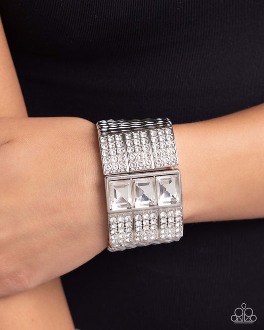 Dramatic Diva White Paparazzi Bracelet with silver bars, rhinestones, and emerald-cut gems on model's wrist